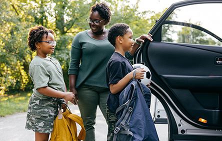 family picking up kids at school