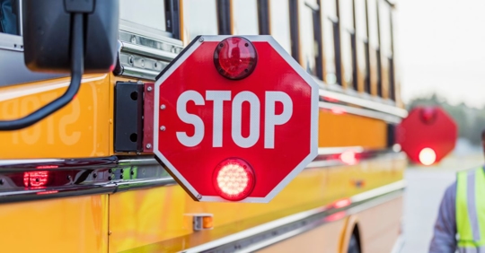 stopped school bus with the stop sign extended