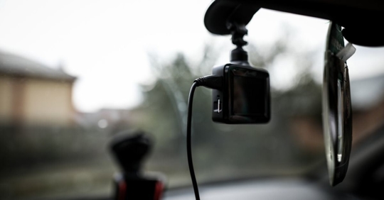 dash cam hanging from the rearview mirror