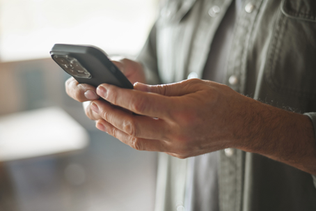 Man receiving an unsolicited text on his phone