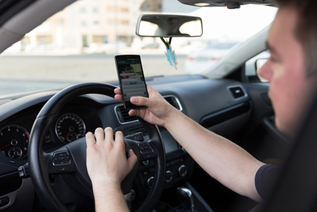 Man texting while driving.