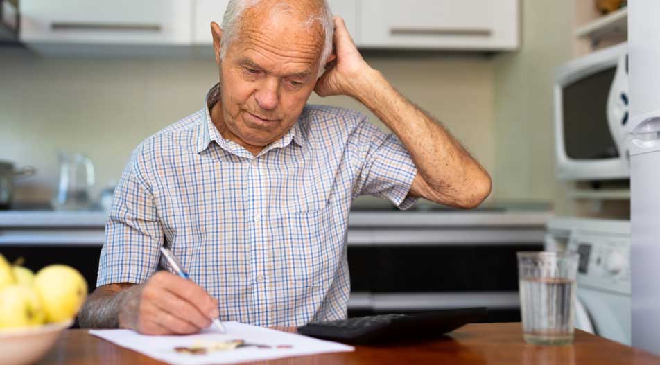 man writing on document